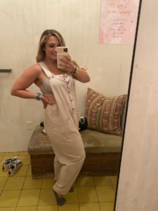 woman trying on linen jumpsuit
