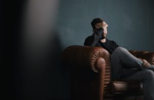 man thinking in the couch