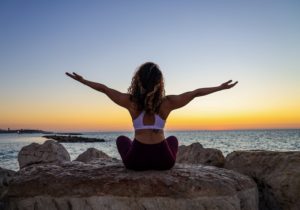 woman meditating by the sea